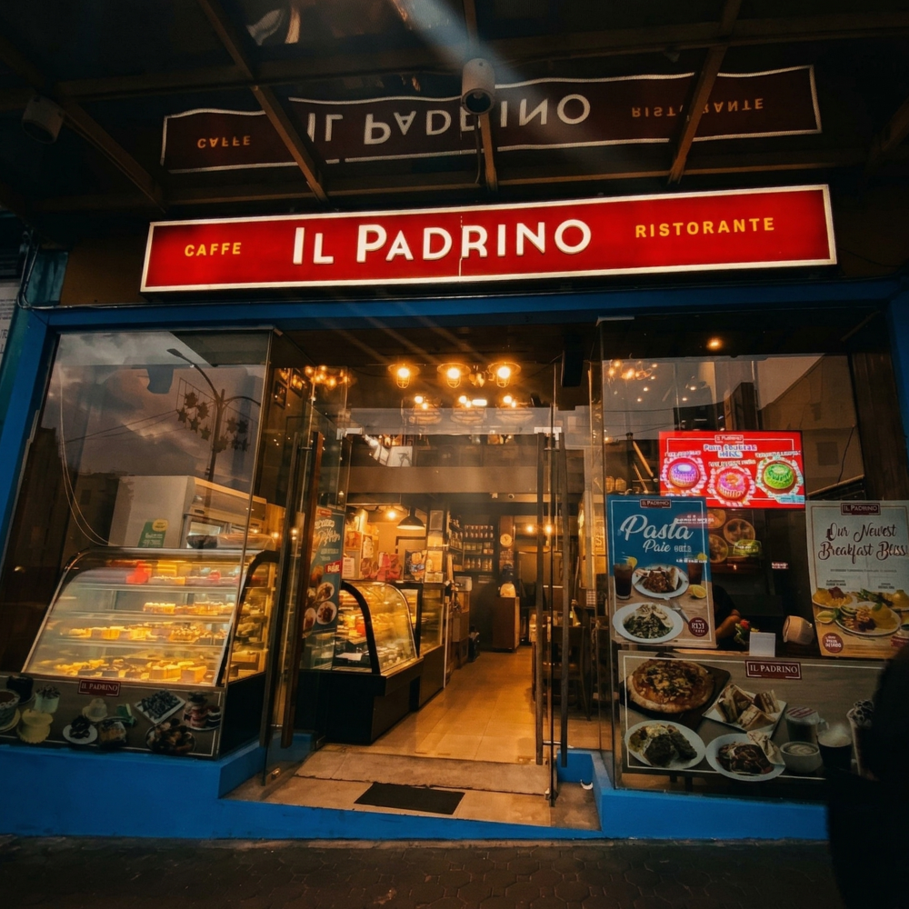 Storefront of "Il Padrino" cafe and restaurant at dusk.