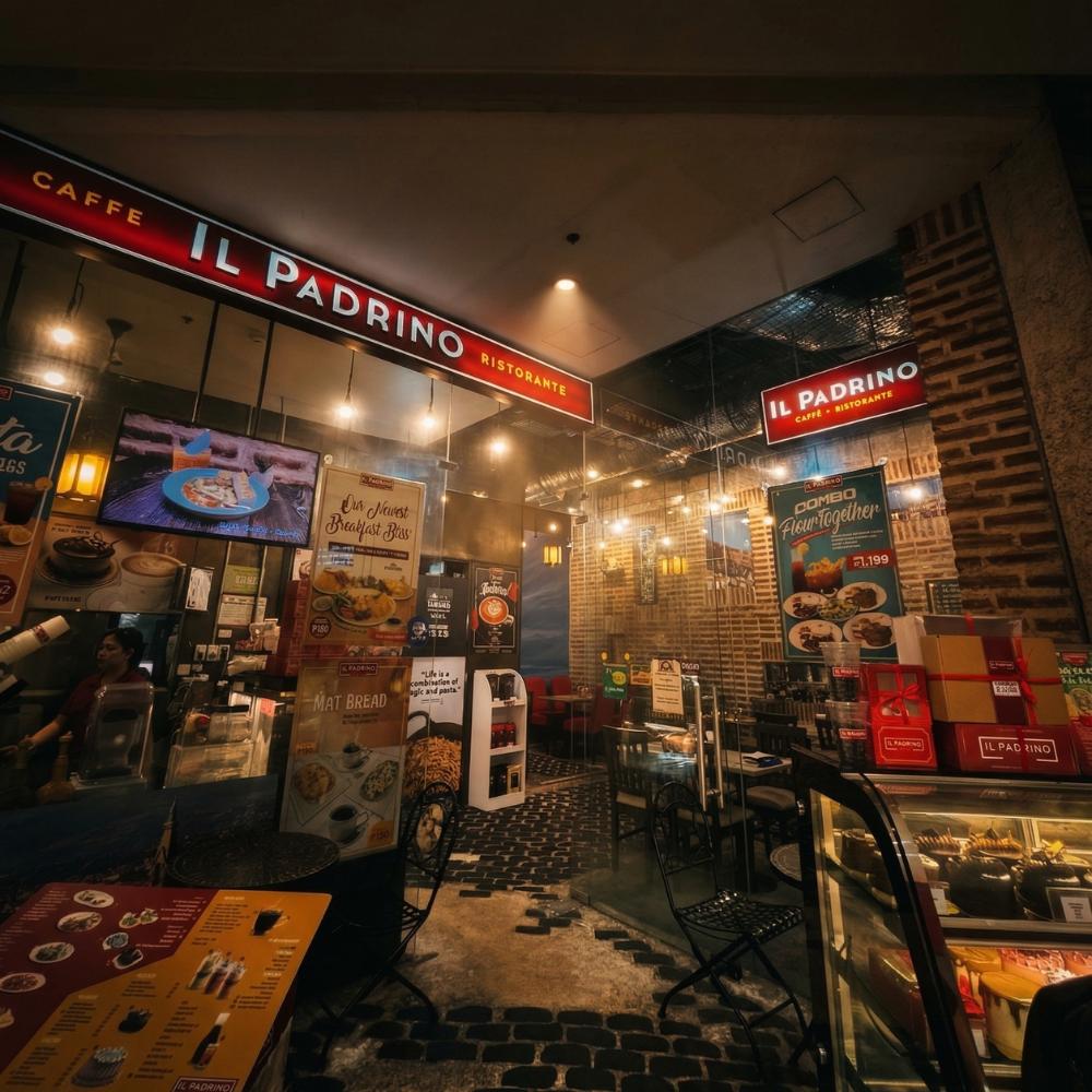 Cozy café named Il Padrino with warm lighting, brick walls, and inviting decor.